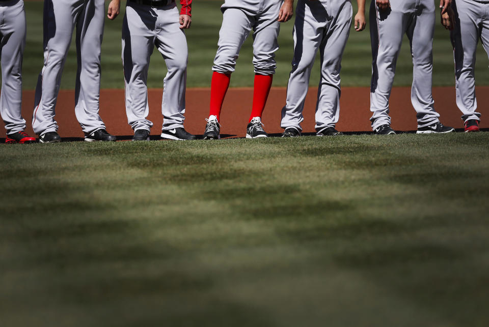 Boston Red Sox relief pitcher Burke Badenhop, center, stands with teammates after being introduced before an opening day baseball game against the Baltimore Orioles, Monday, March 31, 2014, in Baltimore. (AP Photo/Patrick Semansky)