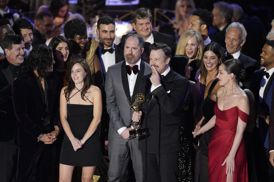 Jason Sudeikis, center, and the cast of "Ted Lasso" accept the Emmy for outstanding comedy series at the 74th Primetime Emmy Awards on Monday, Sept. 12, 2022, at the Microsoft Theater in Los Angeles. (AP Photo/Mark Terrill)