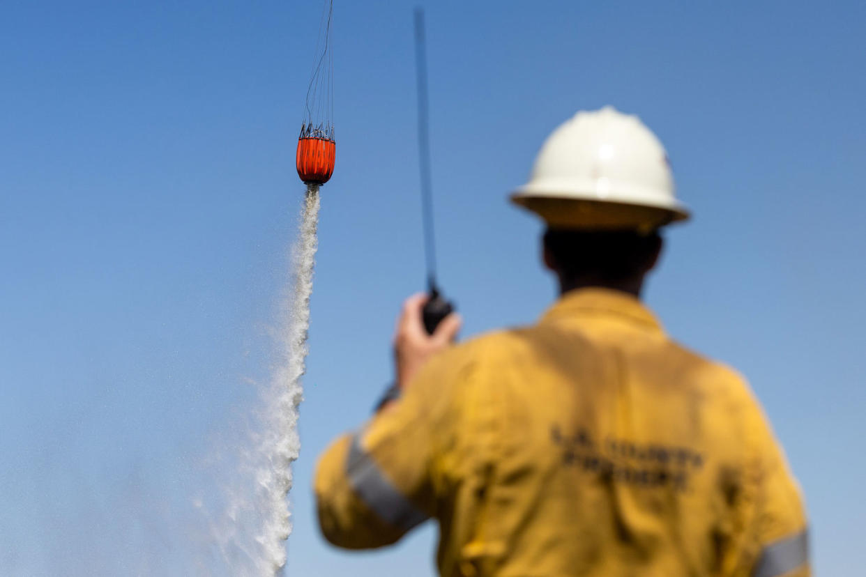 A helicopter drops water during the Park Fire (Benjamin Fanjoy / Bloomberg via Getty Images)