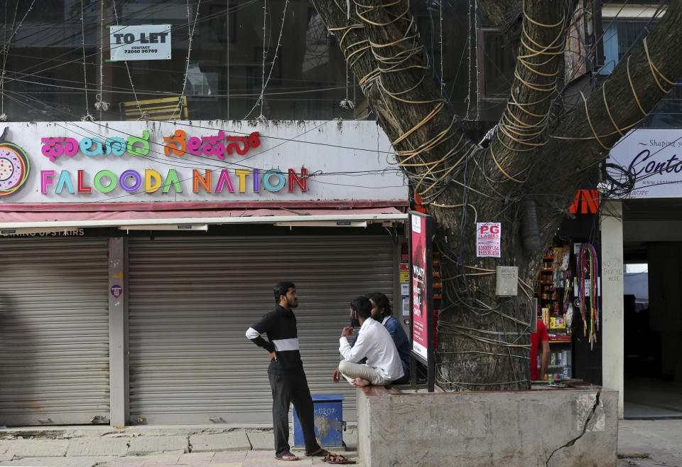 A to-let sign is displayed on the glass of a recently vacated restaurant which closed down due to pandemic in Bengaluru, India, Thursday, Oct. 15, 2020. Thousands of students and professionals who worked for IT companies and lived in the area have moved back to their native places to work remotely. Even as much of the Indian economy has reopened, Bengaluru’s professional workforce is returning to work at a much slower pace than those in most other major cities, raising the risk that the city faces a more protracted recovery. (AP Photo/Aijaz Rahi)