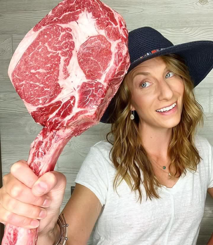 Christina Stawiasz holds a Tomahawk steak from Fairway Packing.