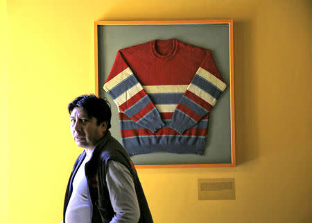 A man stands next to a famous pullover of Bolivia's President Evo Morales at the Orinoca Museum in Orinoca, Bolivia February 2, 2017. REUTERS/David Mercado