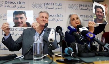 Debra Tice, the mother of American journalist Austin Tice, holds his picture with her husband Marc Tice during a news conference in Beirut, Lebanon July 20, 2017. REUTERS/Jamal Saidi