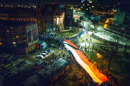 People take part in procession following the coffin of Pawel Adamowicz, Gdansk mayor who died after being stabbed at a charity event, in Gdansk, Poland January 18, 2019. Agencja Gazeta/Renata Dabrowska via REUTERS