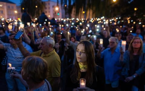 Protesters attend a candle vigil as they take part in demonstration in front of Polish Supreme Court - Credit: WOJTEK RADWANSKI/AFP/Getty Images