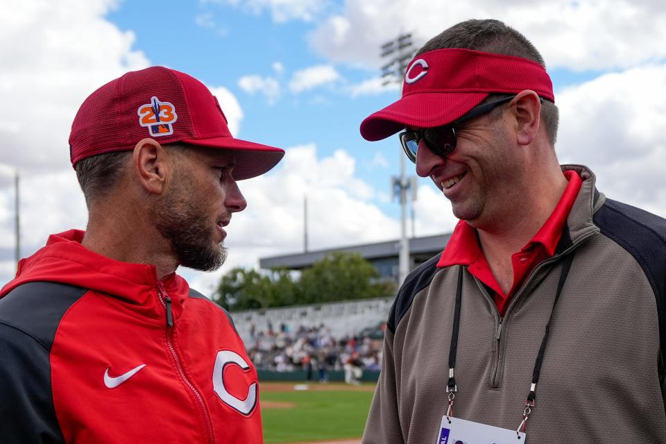 Cincinnati Reds infield coach Jeff Pickler and General Manager Nick Krall talk before a Reds spring training game. Krall has made it a priority to build a culture where players, coaches and staff are excited to go to work every day.