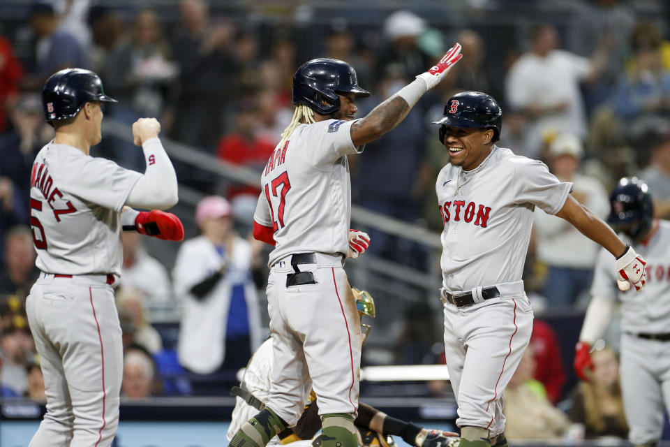 Boston Red Sox' Raimel Tapia, center, congratulates Enmanuel Valdez, right, after Valdez hit a three-run home run during the second inning of a baseball game against the San Diego Padres on Saturday, May 20, 2023, in San Diego. (AP Photo/Brandon Sloter)