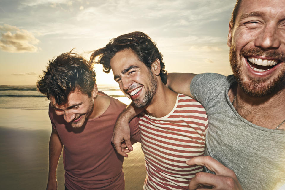 Three men on beach having fun (Getty Images)