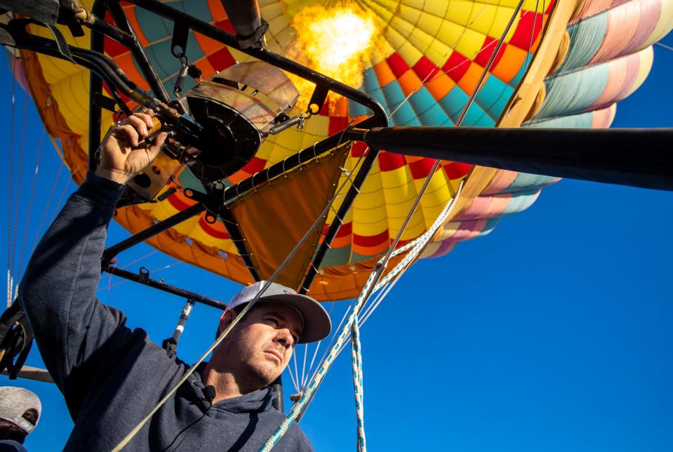 Pilot Justin Wilkinson of Fantasy Balloon Flights keeps his eyes on his target during the annual Cathedral City Hot Air Balloon Festival on Friday.