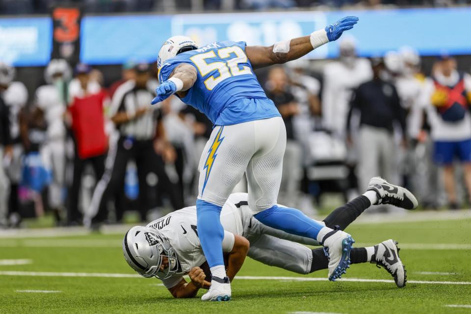 Chargers linebacker Khalil Mack extends his arms as he sacks Raiders quarterback Aidan O'Connell.