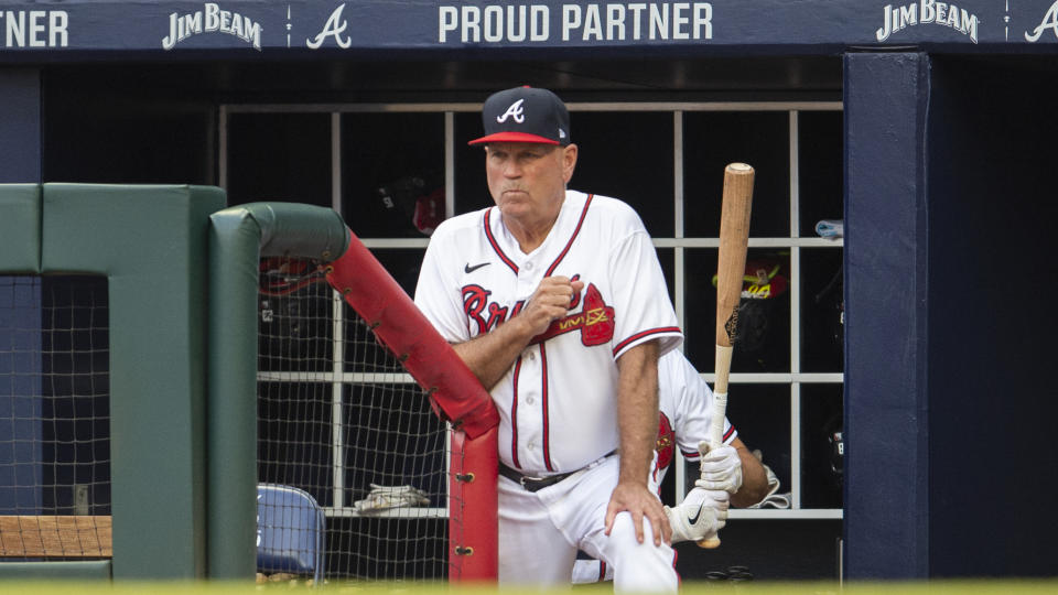 Atlanta Braves manager Brian Snitker watches from the dugout in the first inning of a baseball game against the Houston Astros Saturday, Aug. 20, 2022, in Atlanta. (AP Photo/Hakim Wright Sr.)