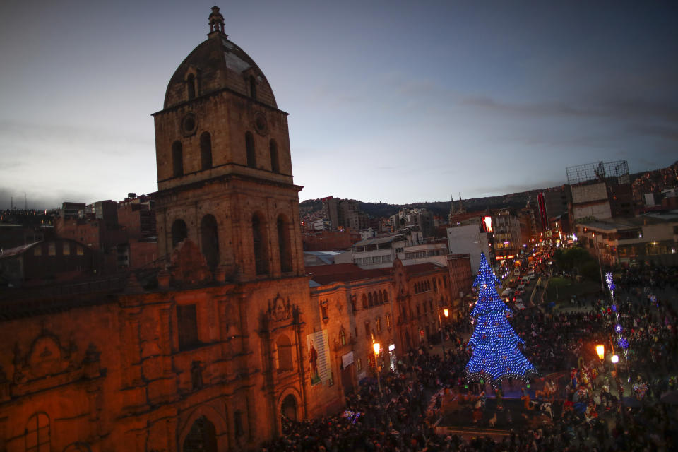 In this picture taken Monday, Jan. 6, 2020, worshippers stand outside San Francisco Church during Three Kings Day celebrations in La Paz, Bolivia. After Mass was celebrated inside the church, many parishioners flocked to indigenous guides to get additional blessings that come from the country's belief in the Pachamama, or mother earth deity. (AP Photo/Natacha Pisarenko)