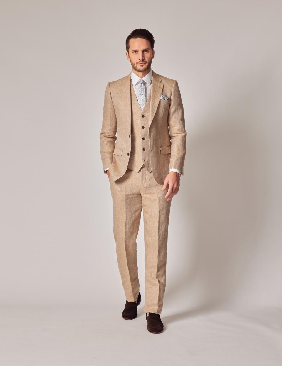 <p><a href="https://go.redirectingat.com?id=74968X1596630&url=https%3A%2F%2Fwww.hawesandcurtis.com%2Fmens-beige-herringbone-linen-3-piece-tailored-fit-italian-suit-1913-collection-jkplta233p-h20v&sref=https%3A%2F%2Fwww.menshealth.com%2Fstyle%2Fg26657806%2Fbest-summer-suits%2F" rel="nofollow noopener" target="_blank" data-ylk="slk:Shop Now;elm:context_link;itc:0;sec:content-canvas" class="link ">Shop Now</a></p><p>Herringbone Linen 3 Piece Tailored Italian Suit</p><p>$699.00</p><p>hawesandcurtis.com</p>