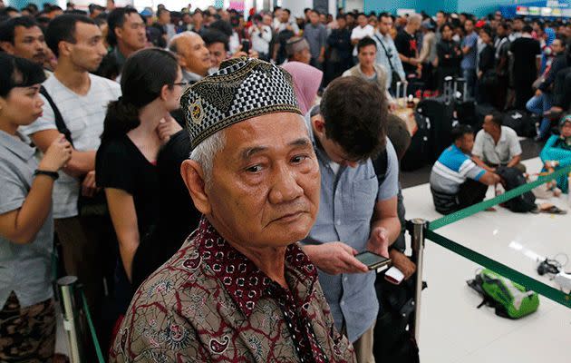 Passengers stand in line to claim their ticket money back. Photo: Reuters