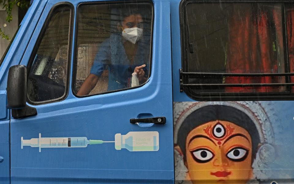 A health worker in a newly introduced 'Vaccination on Wheels' vehicle in Kolkata -  DIBYANGSHU SARKAR / AP