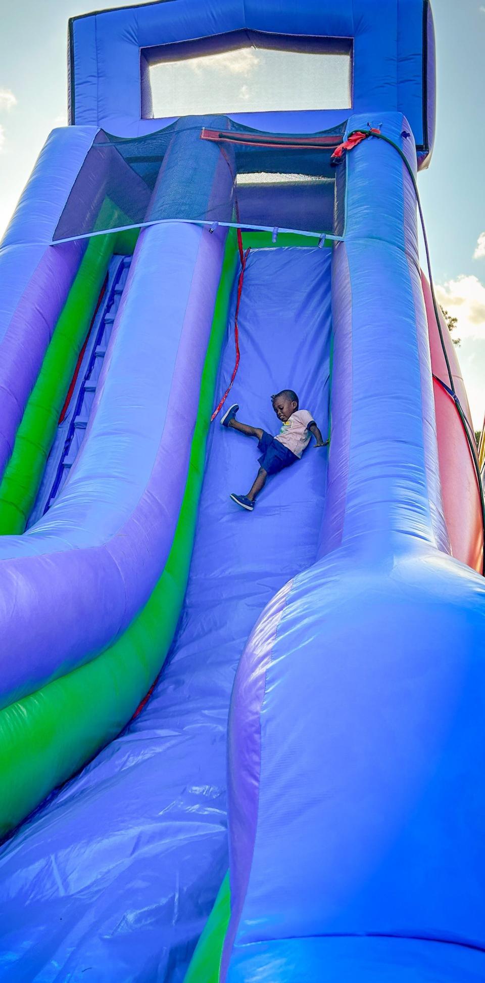 Chase Berry, 2, is all smiles as he goes down the inflatable slide at Rockledge Police Department's 2023 National Night Out on Oct. 3.