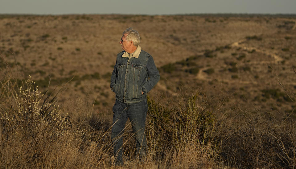 Rancher Randy Nunns watches sunset on the Monarch Ranch near Del Rio, Texas, Thursday, Feb. 16, 2023. Nunns and fellow landowners along the Devil's River argue that proposed wind turbines would kill birds, bats and disrupt monarch butterflies migrating to Mexico and impact ecotourism, a main source of income for many. (AP Photo/Eric Gay)