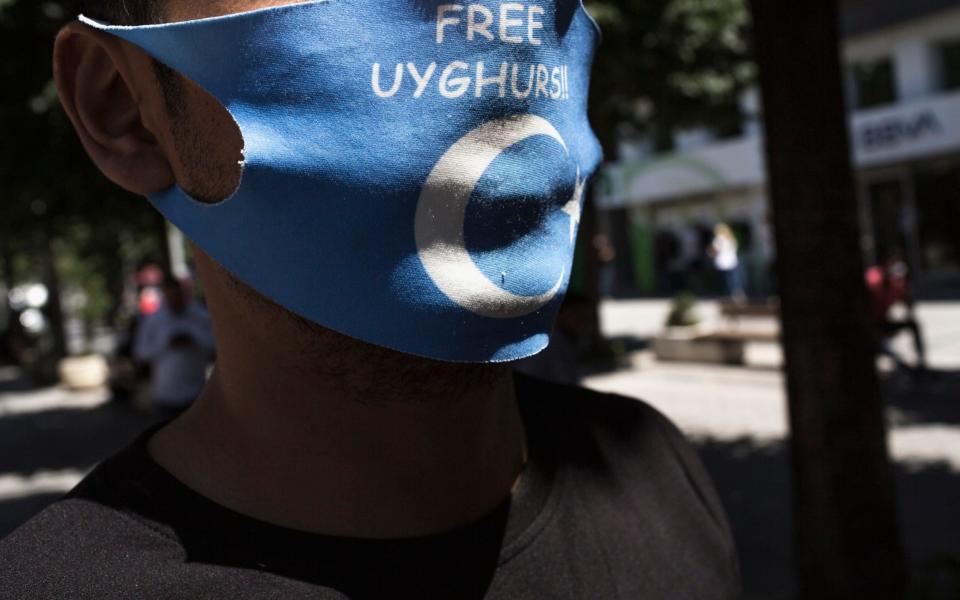 An anti-china activist wears a Free Uighurs mask, in Istanbul, Turkey - Sam Tarling for The Telegraph 