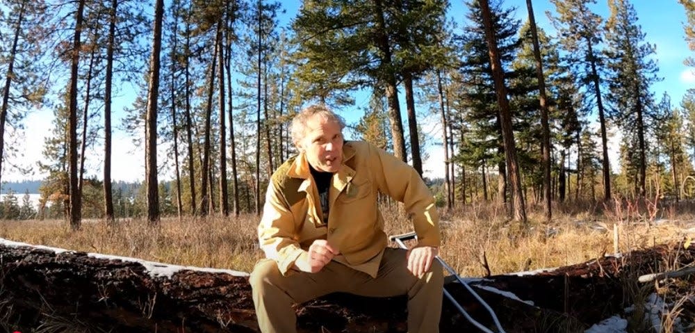 Paul Harrell sitting on a log in the final video