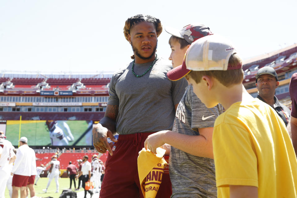 Washington Commanders defensive end Chase Young (99) chats with young fans before a NFL Preseason football game between the Carolina Panthers and the Washington Commanders on Saturday, Aug. 13, 2022 at FedExField in Landover, Md. (Shaban Athuman/Richmond Times-Dispatch via AP)