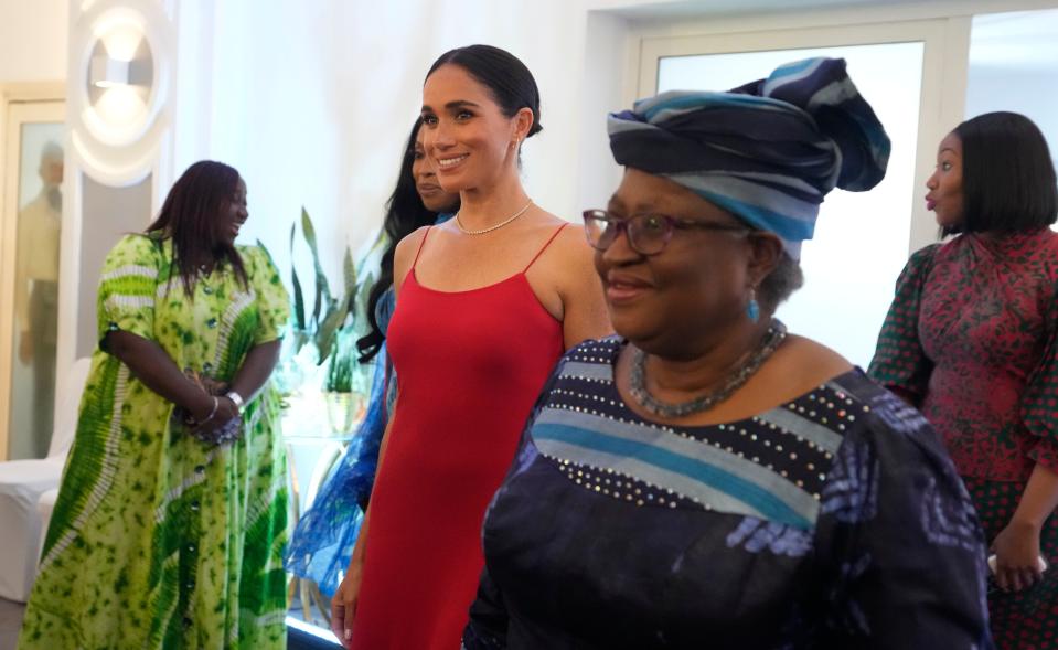 Meghan, the Duchess of Sussex, left, walks alongside Ngozi Okonjo-Iweala, right, Director-General of the World Trade Organization, during an event in Abuja, Nigeria, Saturday (AP)