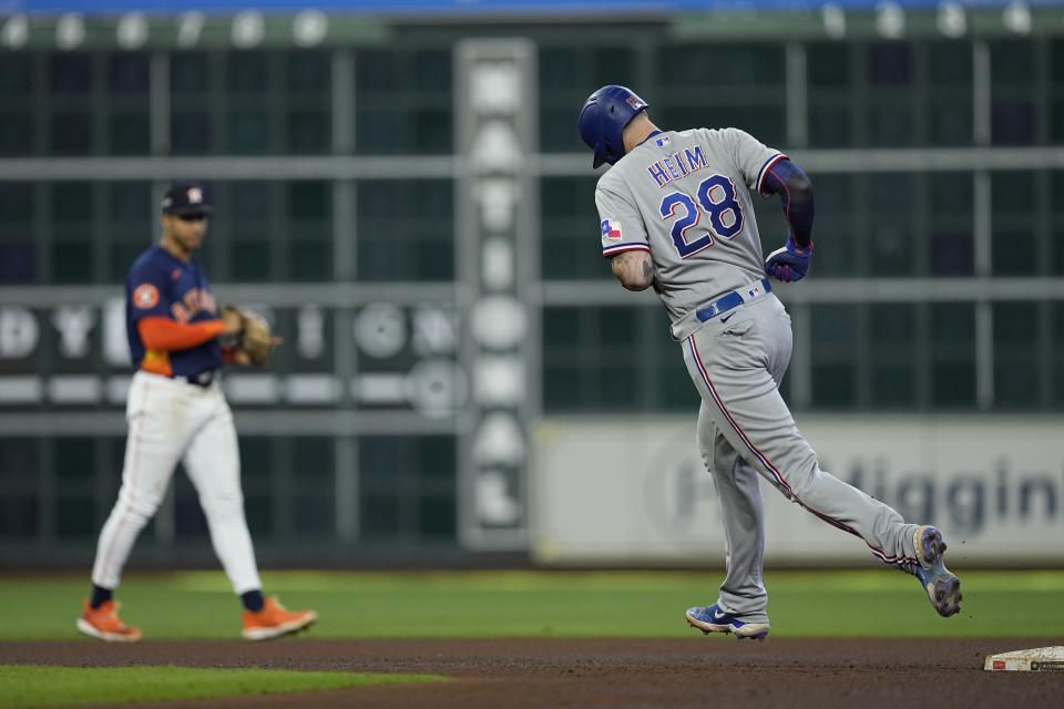 Texas Rangers' Jonah Heim rounds the bases after hitting a home run during the third inning of Game 2 of the baseball AL Championship Series against the Houston Astros Monday, Oct. 16, 2023, in Houston. (AP Photo/David J. Phillip)