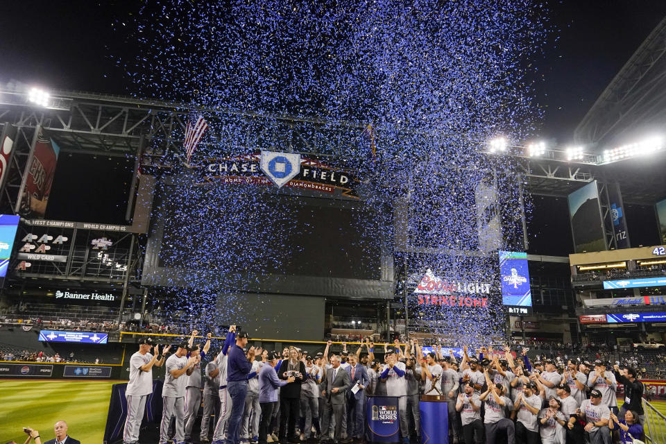 Texas Rangers celebrate with the trophy after winning Game 5 of the baseball World Series against the Arizona Diamondbacks Wednesday, Nov. 1, 2023, in Phoenix. The Rangers won 5-0 to win the series 4-1. (AP Photo/Brynn Anderson)