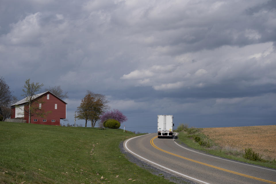 In this April 7, 2020, photo, trucker Sammy Lloyd pulls an empty trailer behind his semitruck as he departs the Target Distribution Center in Stuarts Draft, Va., after delivering a COVID-19 emergency relief load he pulled from California. (AP Photo/Carolyn Kaster)
