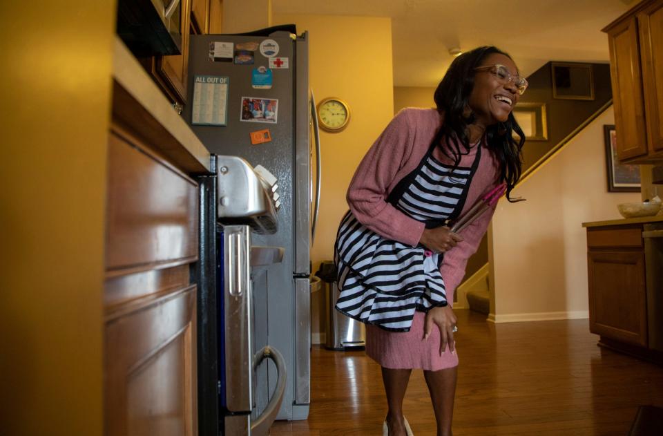 Tiffany Willis, the founder of The Wifestyle Academy, smiles after putting in a batch of chocolate chip cookie dough inside her oven in Southfield on October 12, 2022. In her academy, Willis coaches other women on how to tap into their feminine side, setting boundaries and embracing their womanhood all so they can be a better them while giving their partner their best and being ok with celebrating them. 