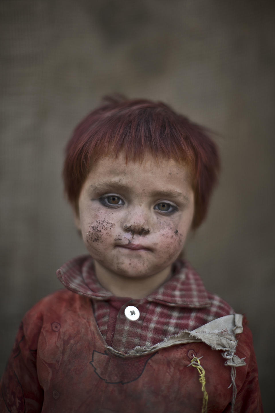 In this Friday, Jan. 24, 2014 photo, Afghan refugee girl, Gul Bibi Shamra, 3, poses for a picture, while playing with other children in a slum on the outskirts of Islamabad, Pakistan. For more than three decades, Pakistan has been home to one of the world’s largest refugee communities: hundreds of thousands of Afghans who have fled the repeated wars and fighting their country has undergone. Since the 2002 U.S.-led invasion of Afghanistan, some 3.8 million Afghans have returned to their home country, according to the U.N.’s refugee agency. (AP Photo/Muhammed Muheisen)