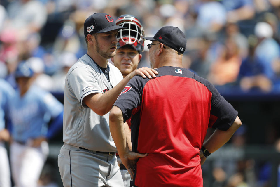 Cleveland Indians pitcher Trevor Bauer, left, reacts as he is taken out by manager Terry Francona in the fifth inning of a baseball game against the Kansas City Royals at Kauffman Stadium in Kansas City, Mo., Sunday, July 28, 2019. (AP Photo/Colin E. Braley)