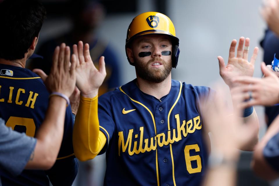 Owen Miller celebrates in the dugout after scoring for the Brewers on a single by Rowdy Tellez off Guardians starter Aaron Civale during the third inning, Sunday, June 25, 2023, in Cleveland.