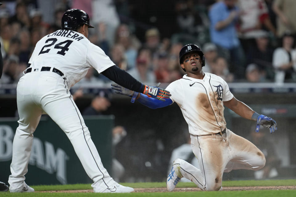 Detroit Tigers' Andy Ibanez celebrates scoring with Miguel Cabrera (24) in the fifth inning of a baseball game against the Cincinnati Reds, Tuesday, Sept. 12, 2023, in Detroit. (AP Photo/Paul Sancya)