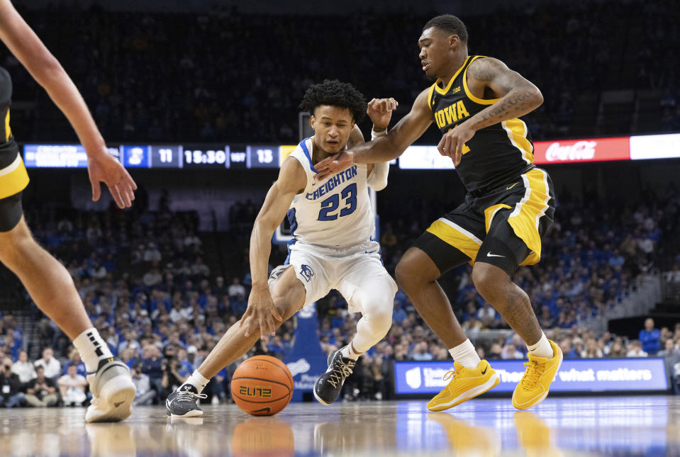 Creighton's Trey Alexander, left, drives to the basket against Iowa's Tony Perkins during the first half of an NCAA college basketball game Tuesday, Nov. 14, 2023, in Omaha, Neb. (AP Photo/Rebecca S. Gratz)