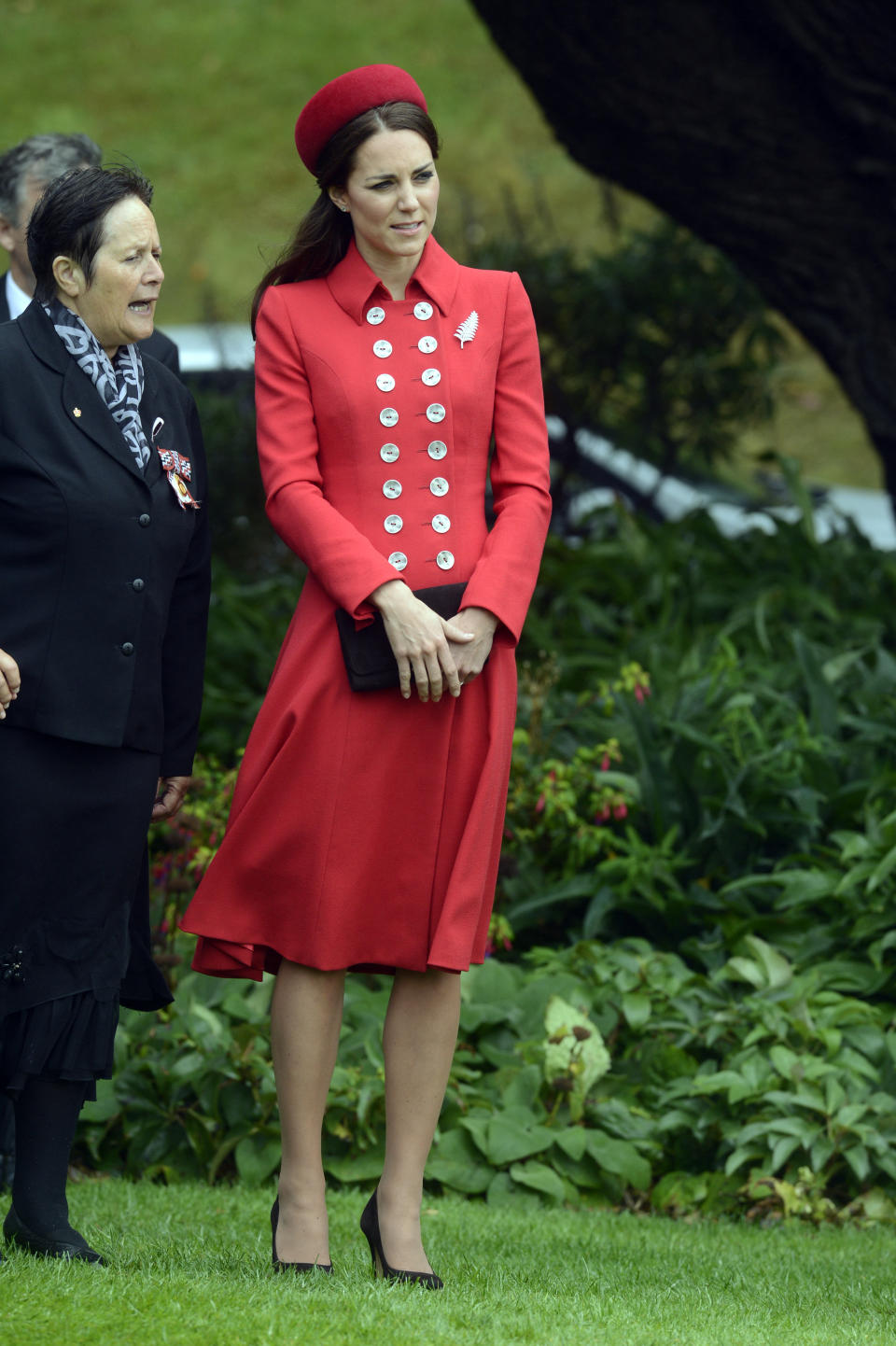 Kate channeled Princess Diana in a red military-esque Catherine Walker coat while arriving in New Zealand on April 7, 2014. 