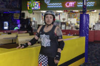 Amanda "Curly Fry" Urena, stands for a photograph, Tuesday, March 19, 2023, at United Skates of America in Seaford, N.Y. (AP Photo/Jeenah Moon)