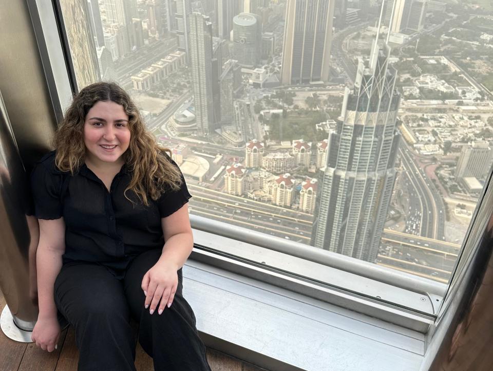 Posing on the windowsill on the 124th floor of the Burj Khalifa.