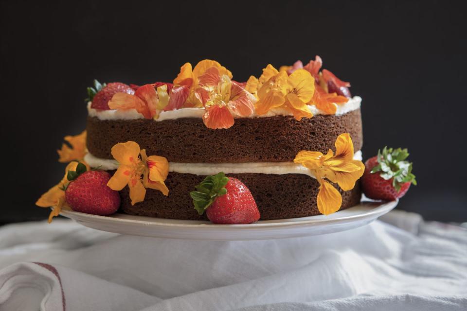 edible flowers on two layer spice cake with buttercream icing
