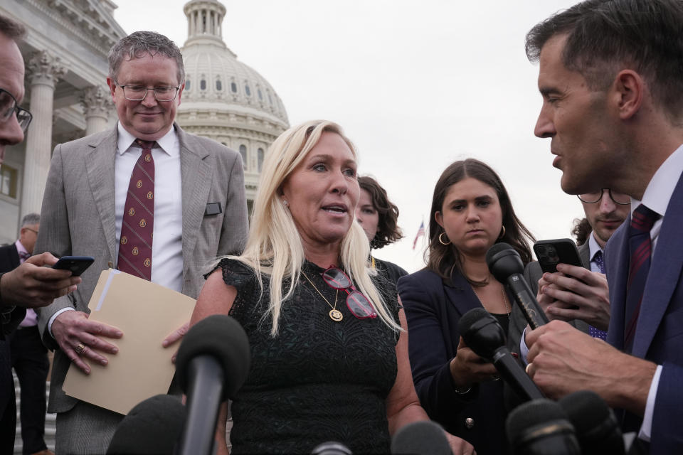 Rep. Marjorie Taylor Greene, R-Ga., joined by Rep. Thomas Massie, R-Ky., speaks to reporters after she tried and failed to oust Speaker Mike Johnson, her long-shot effort swiftly and resoundingly rejected by Democrats and Republicans tired of the political chaos, at the Capitol in Washington, Wednesday, May 8, 2024. (AP Photo/J. Scott Applewhite)