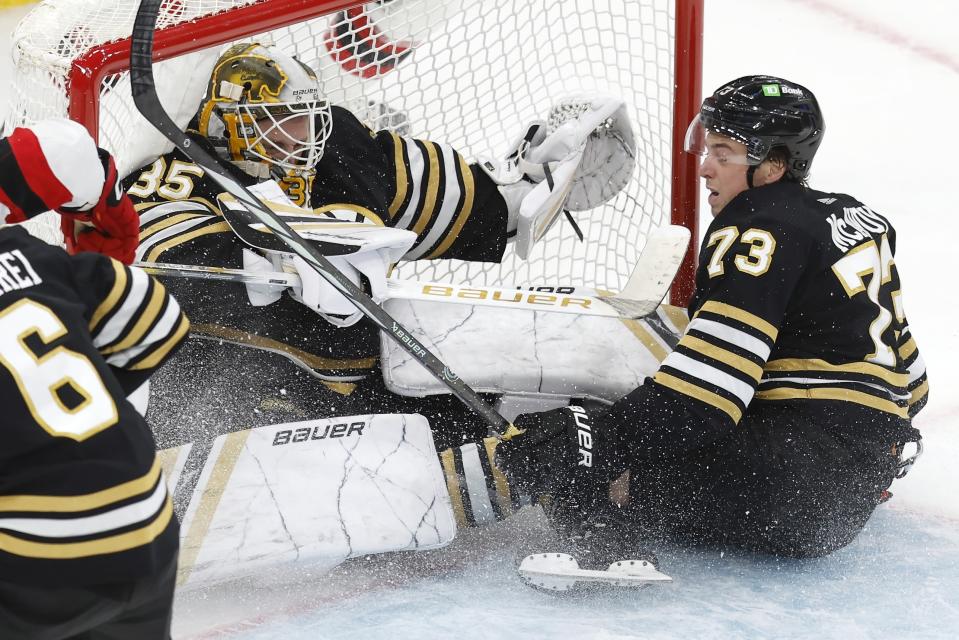 Boston Bruins' Charlie McAvoy (73) collides with Boston Bruins' Linus Ullmark (35) during the third period of the team's NHL hockey game against the New Jersey Devils, Saturday, Dec. 30, 2023, in Boston. (AP Photo/Michael Dwyer)