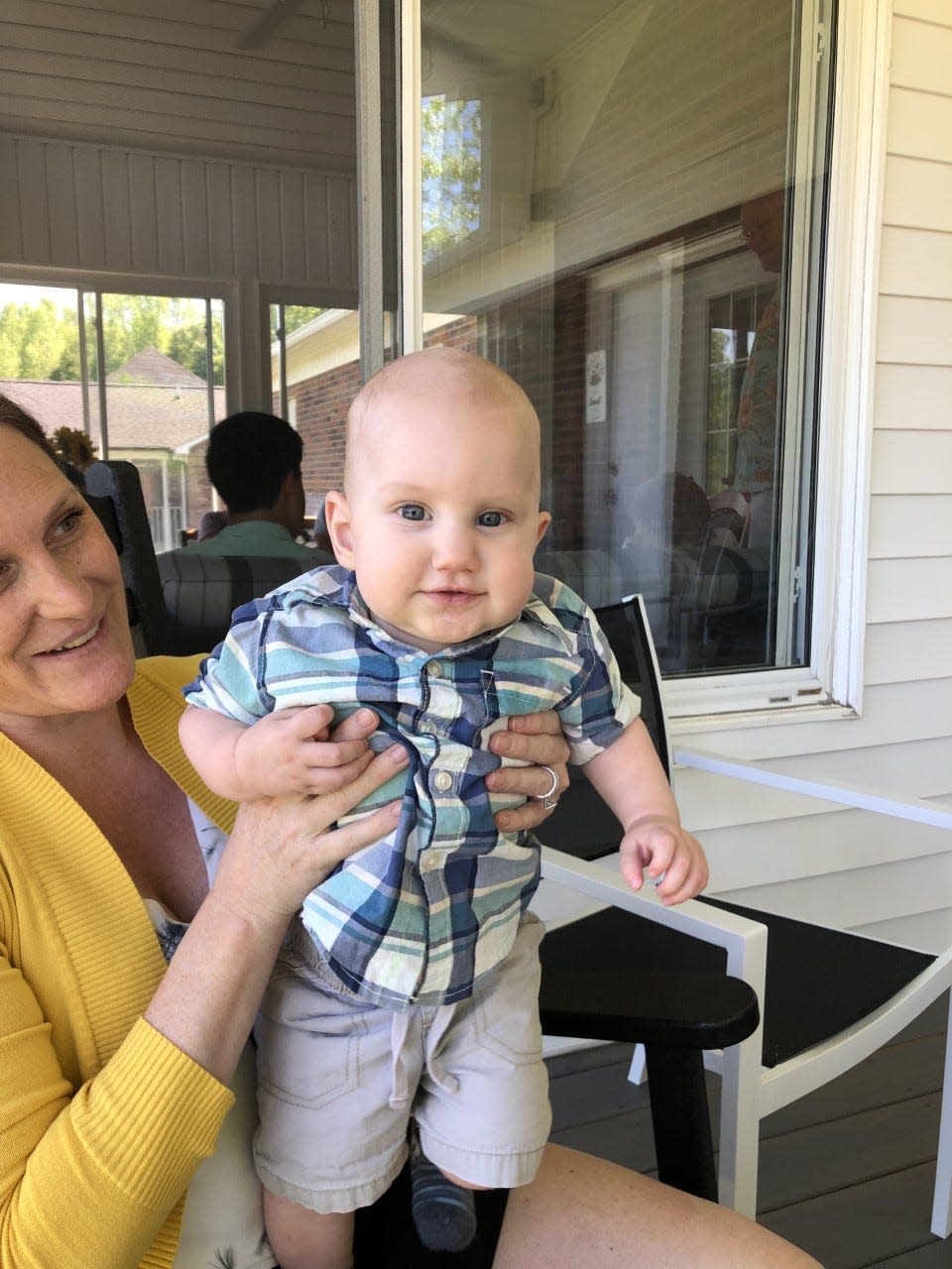 Stephanie is holding her youngest son, Aiden.