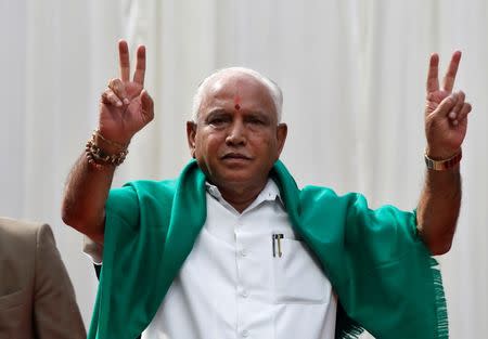 Bharatiya Janata Party (BJP) leader B. S. Yeddyurappa flashes the victory sign after taking oath as Chief Minister of the southern state of Karnataka inside the governor's house in Bengaluru, India, May 17, 2018. REUTERS/Abhishek N. Chinnappa