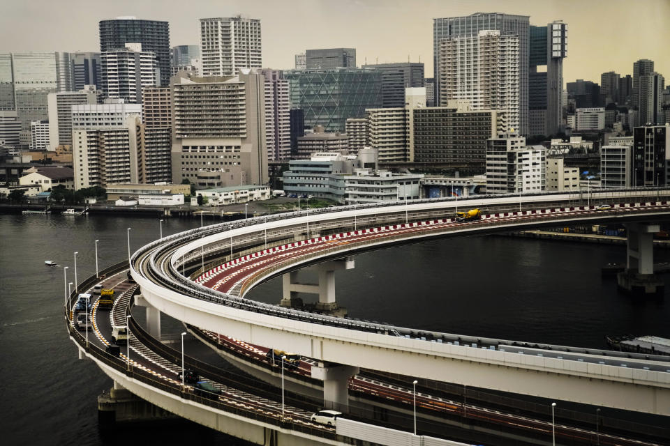 Motorists drive along a spiral ramp onto the Rainbow Bridge, Tuesday, July 13, 2021, in Tokyo. (AP Photo/Jae C. Hong)