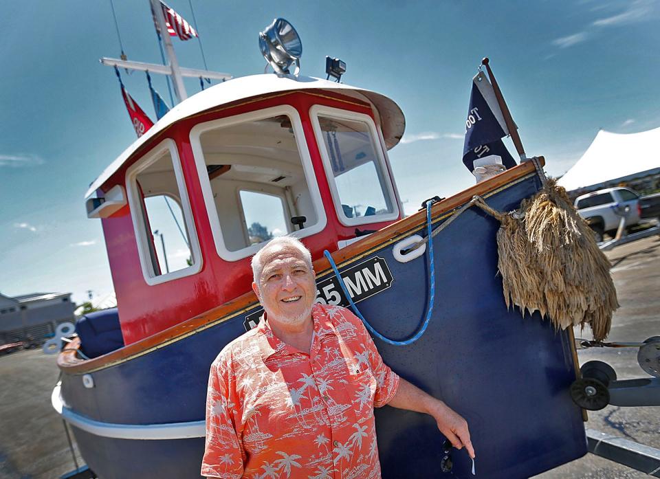 Mike Magnant, of Middleboro, with his mini tugboat Toot Toot, in Plymouth Harbor Wednesday, July 27, 2022.