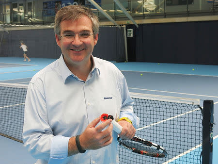 Eric Babolat, CEO and Chairman of Babolat, poses for a photograph holding a hi-tech, 'connected' tennis racquet at Britain's National Tennis Centre in Roehampton, south-west London, May 12, 2014. REUTERS/Ossian Shine