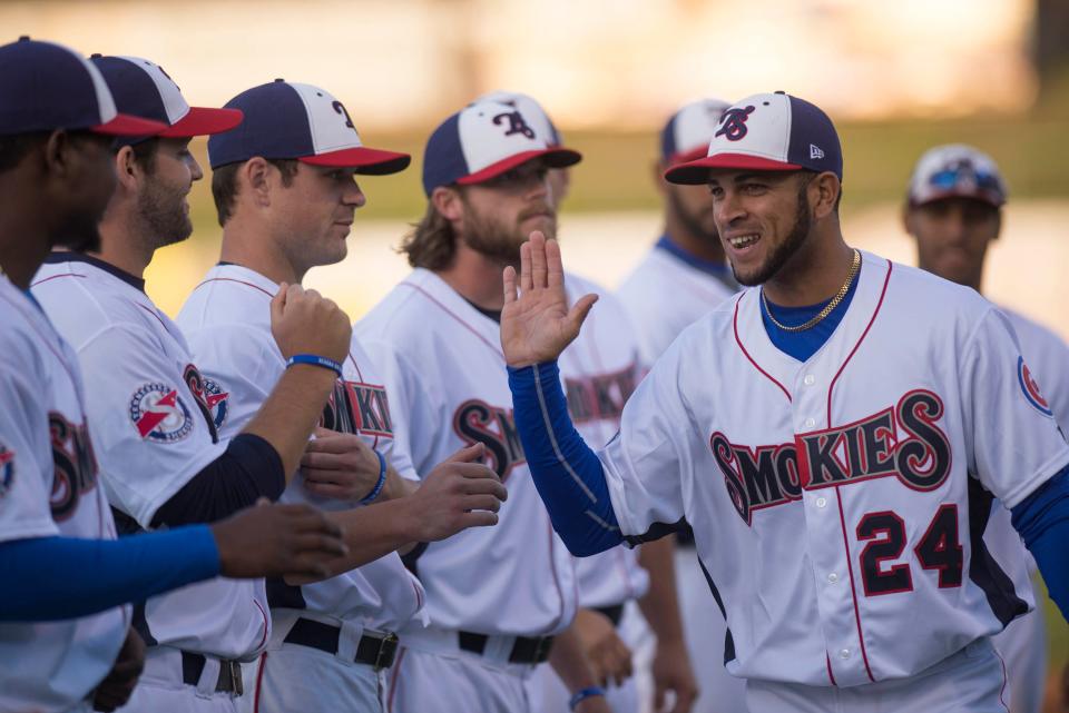 Tennessee Smokies outfielder Rubi Silva gets the glad hand from teammates during player introductions before the home opener in 2014. The team, which has played in Sevier County since 2000,  will be renamed the Knoxville Smokies when it moves to a new stadium planned for the Old City in downtown Knoxville.