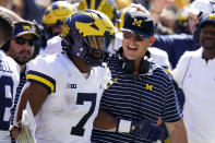Michigan running back Donovan Edwards (7) celebrates with head coach Jim Harbaugh after catching a 12-yard touchdown pass during the second half of an NCAA college football game against Iowa, Saturday, Oct. 1, 2022, in Iowa City, Iowa. Michigan won 27-14.(AP Photo/Charlie Neibergall)