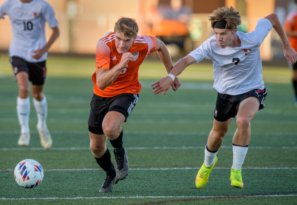 Washington's Mitch Coughlon, left, and Metamora's Alex Cullen chase the ball in the first half Tuesday, Aug. 30, 2022 at Babcook Field in Washington.