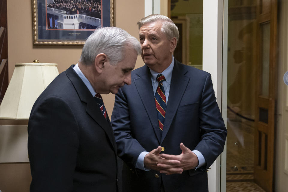 Sen. Jack Reed, D-R.I., left, and Sen. Lindsey Graham, R-S.C., members of the Senate Armed Services Committee, confer prior to a news conference to say they are disagreeing with President Donald Trump's sudden decision to pull all 2,000 U.S. troops out of Syria, at the Capitol in Washington, Thursday, Dec. 20, 2018. (AP Photo/J. Scott Applewhite)