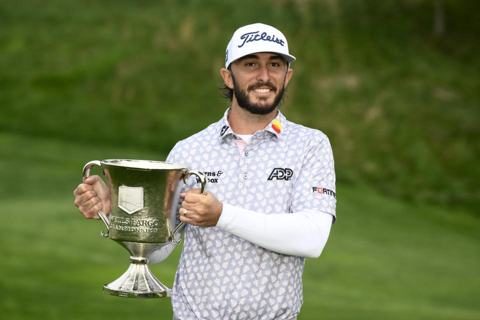 Max Homa holds the trophy after winning the Wells Fargo Championship golf tournament, Sunday, May 8, 2022, at TPC Potomac at Avenel Farm golf club in Potomac, Md. (AP Photo/Nick Wass)